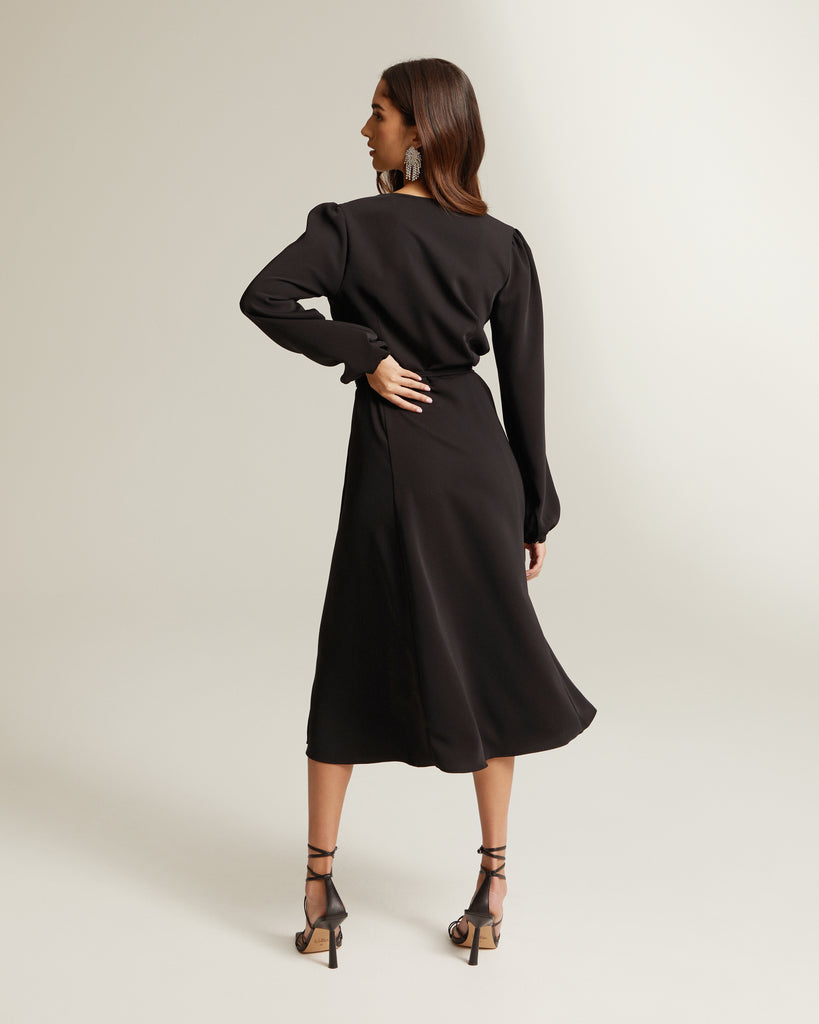 back shot of black wrap dress with thigh split and long sleeves